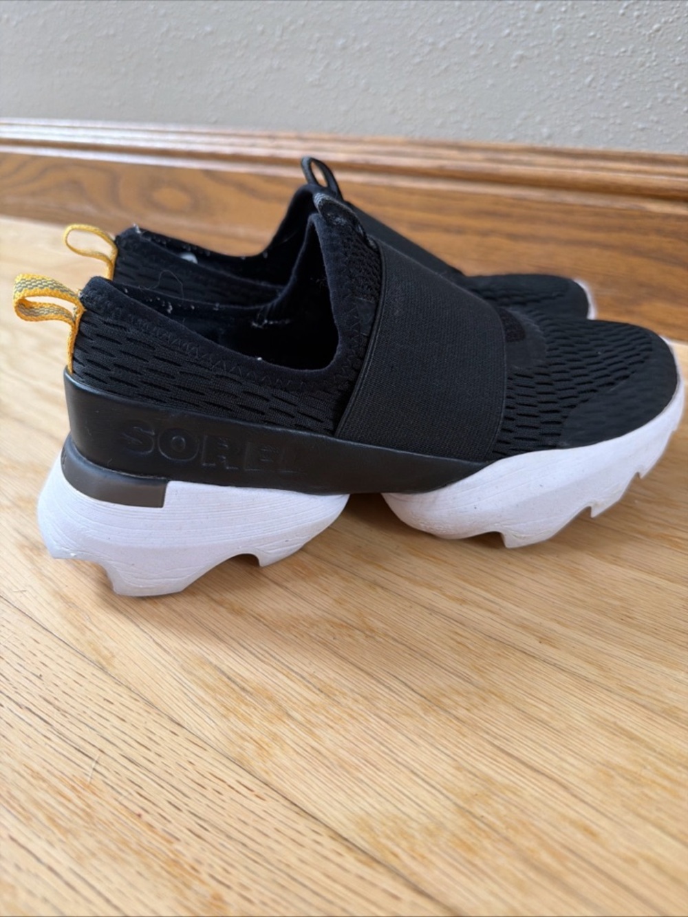 Sorel Black kinetic Knit Slip-On Sneakers with White Sole and Yellow Heel Loop